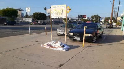 Homeless sleeping next to the street