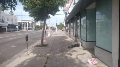 Homeless sleeping next to the street