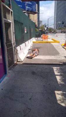 Homeless sleeping next to a construction site