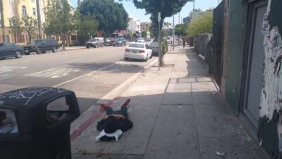 Homeless sleeping next to the street