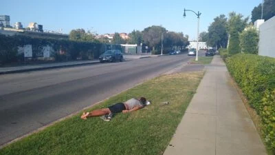Homeless sleeping next to the street