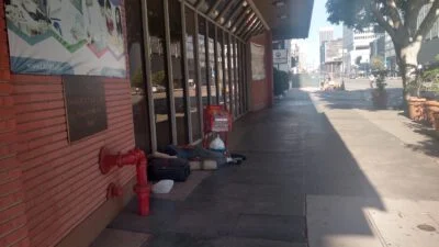 Homeless sleeping next to the street