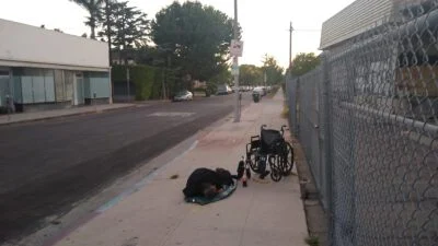 Homeless sleeping next to the street