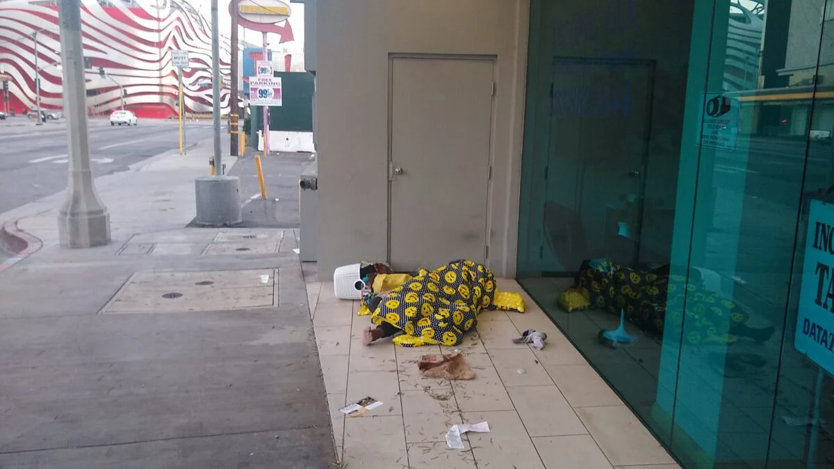 Homeless sleeping next to food, found in the trash