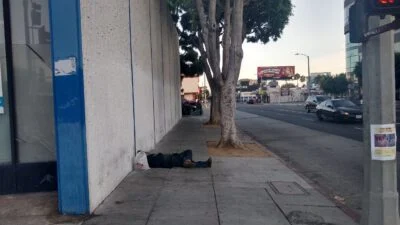 Homeless sleeping next to the street